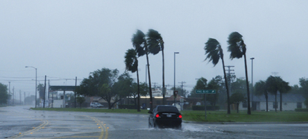 Graphic showing a car traveling in heavy rain and wind