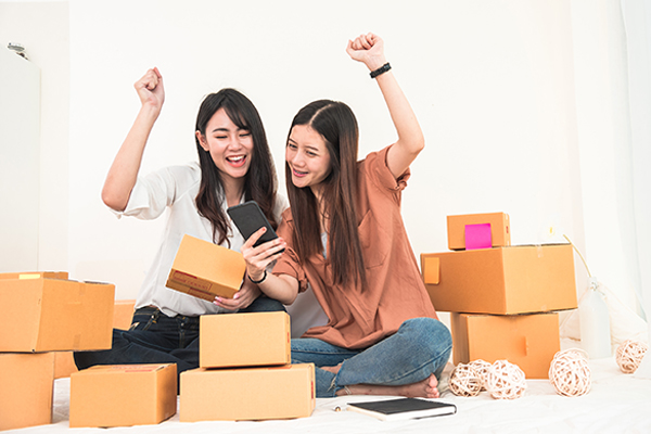 women packing boxes to ship
