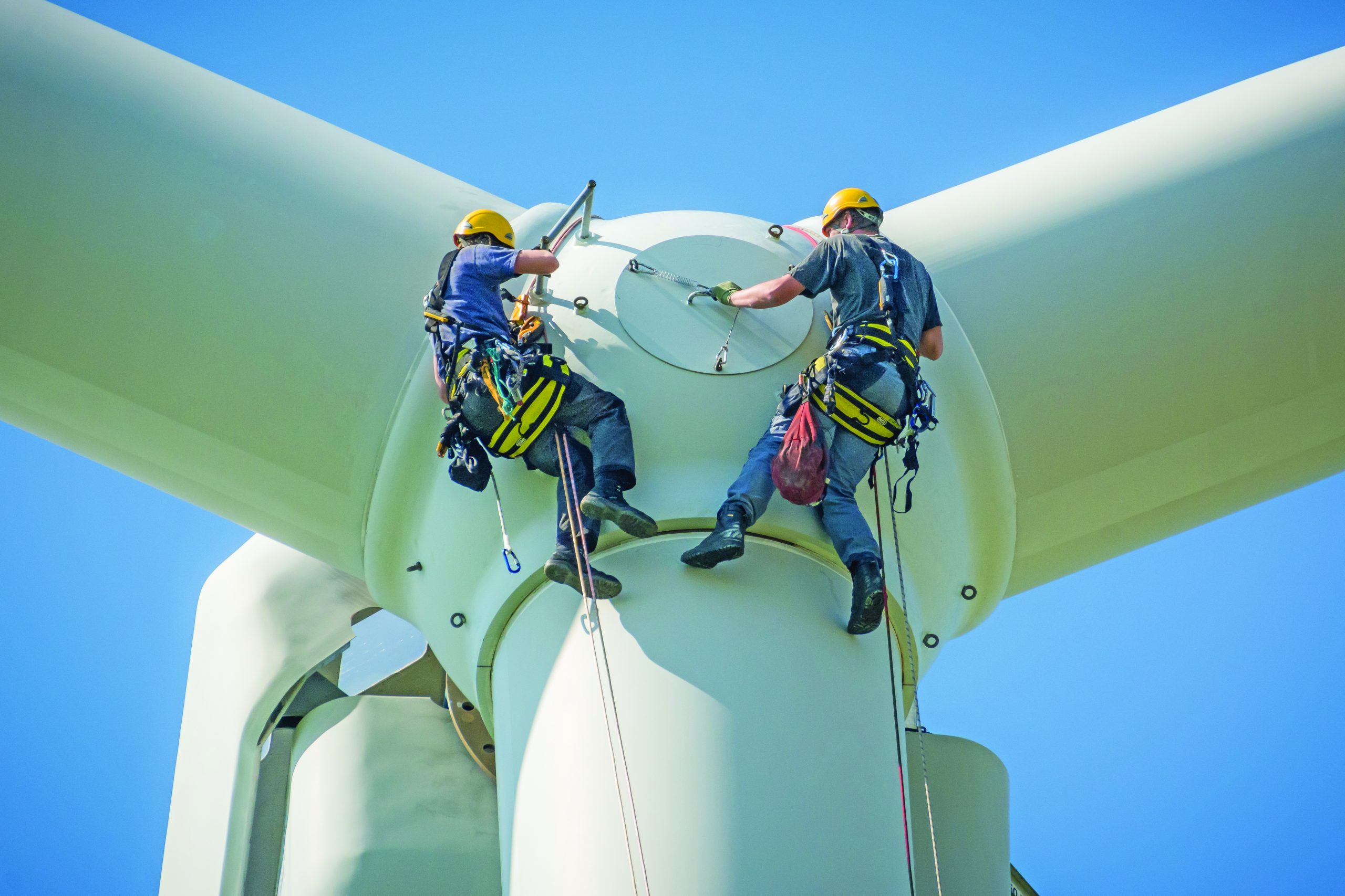 maintenance being done on the exterior of a wind turbine