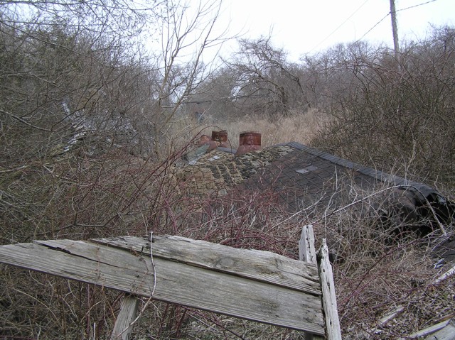 image 20 - a brick wall fallen with roof chimney stacks on the ground in the background