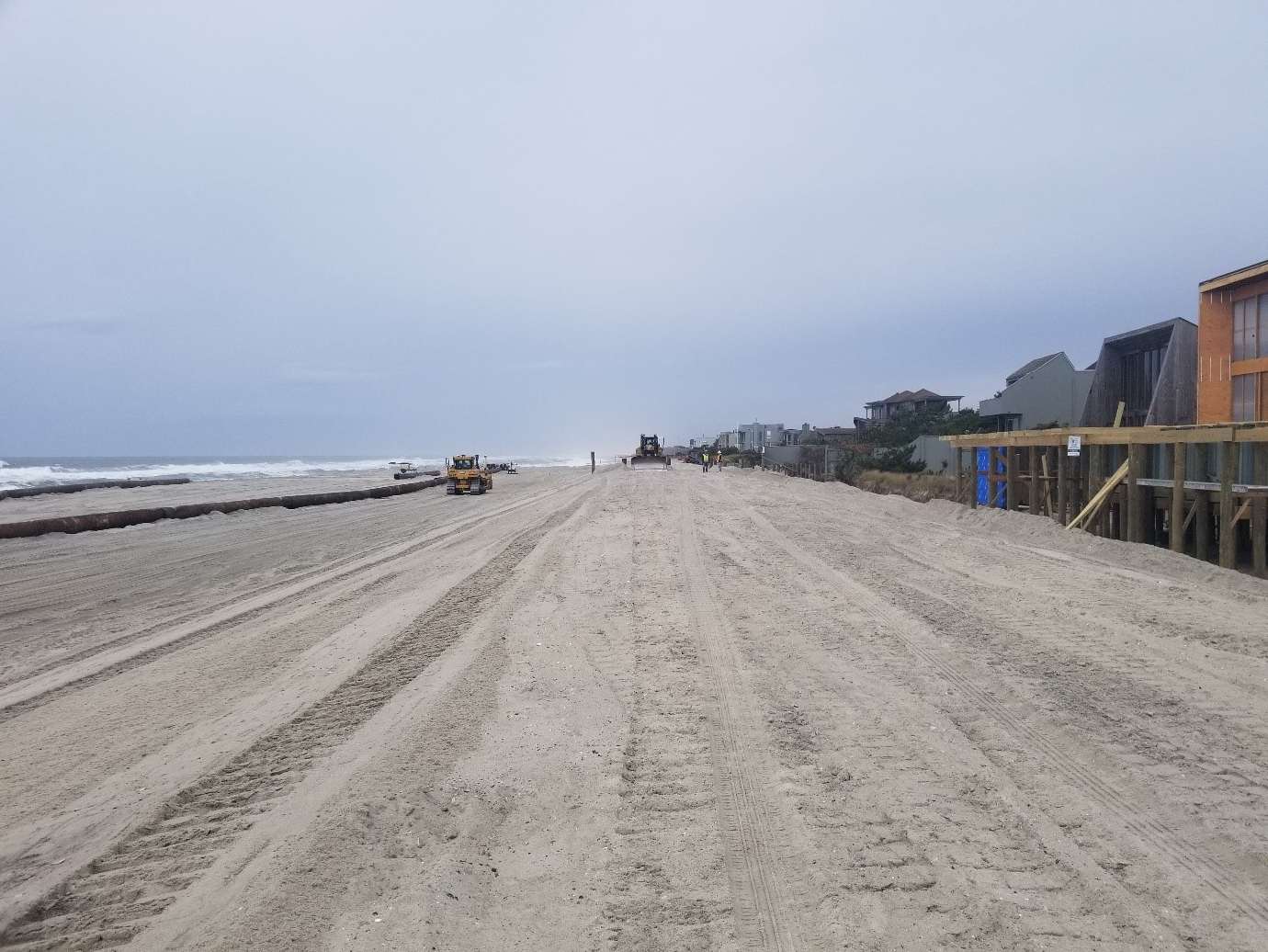 backhoes and trucks working on davis park shoreline