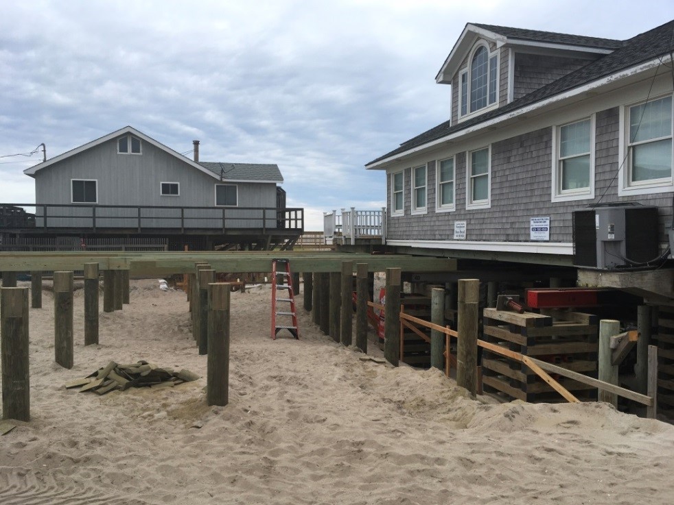 image of a house under reconstruction in a sandy beach area