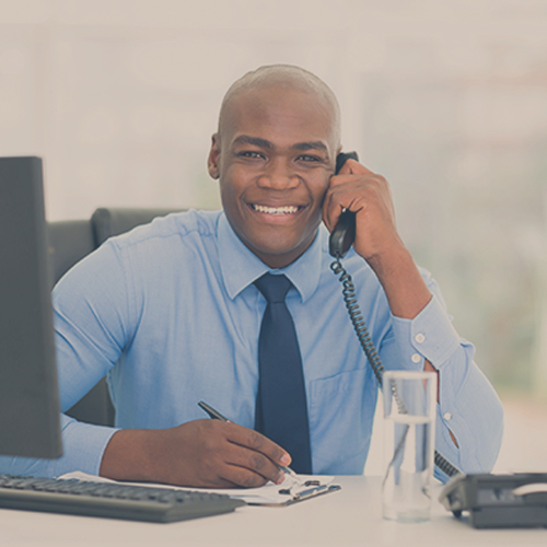 a man in an office answering a phone
