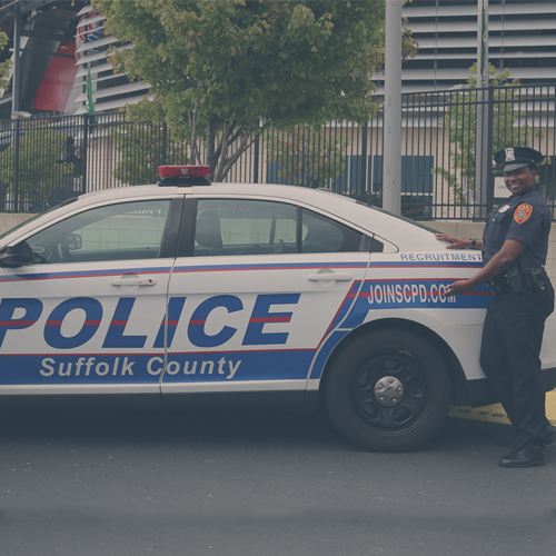 a police officer standing in front of a squad car