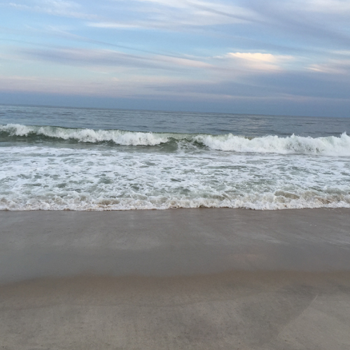 a small wave at a beach shore