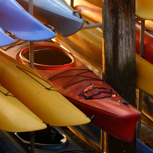 a group of kayaks being stored together