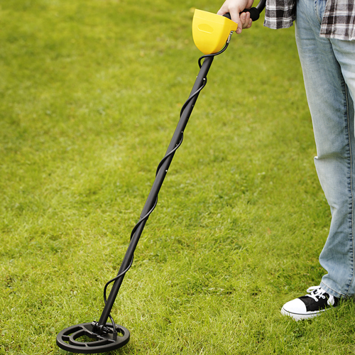 a person using a metal detector