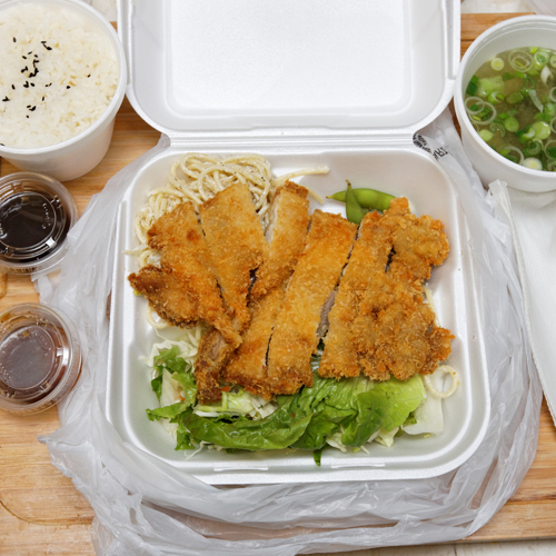 a portable food container holding a chicken salad