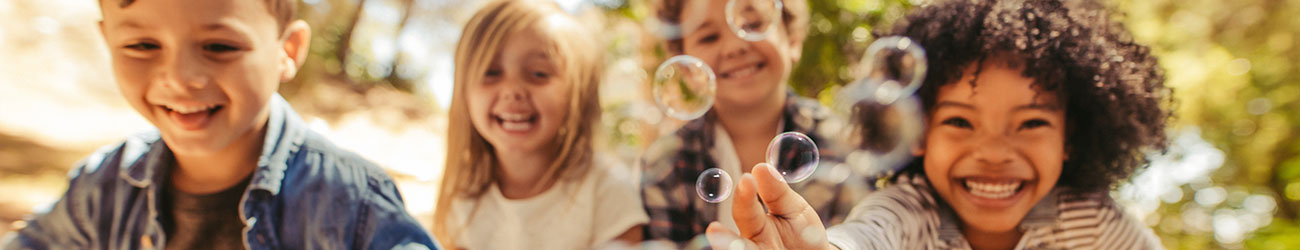 group of children blowing bubbles